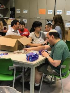 Volunteers assembling care packages at table