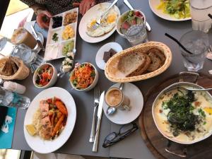A table filled with plates of food and bowls.