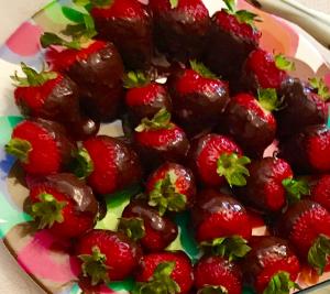 A plate of strawberries on top of the table.