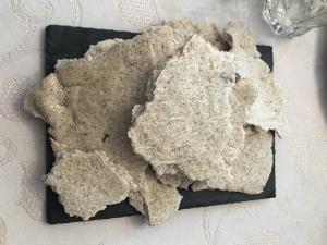 Homemade rustic crispbreads on black slate