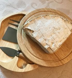 A wooden plate with a piece of cake on it