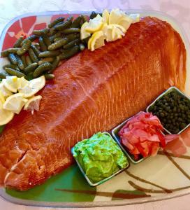 Whole salmon fillet with lemon and condiments