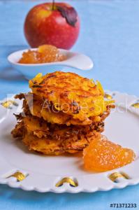 Stack of crispy latkes with applesauce
