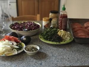 A table with food on it and bowls of condiments.
