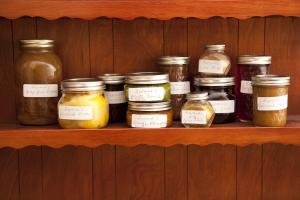 A shelf with jars of food on top of it.