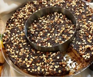 Chocolate cake with chopped nuts and missing slice