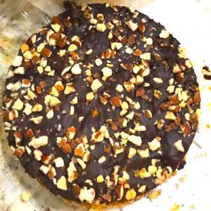 A chocolate cake with nuts on top of it.