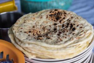 Stack of charred flatbreads on plate