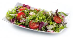 A plate of salad with tomatoes and lettuce.