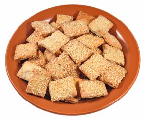 Square sesame seed crackers on orange plate