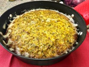 Golden cheesy frittata in a skillet