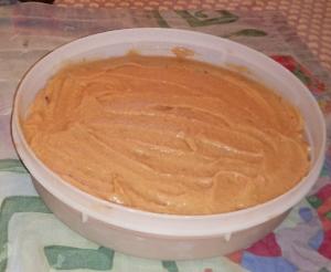 Creamy orange puree in plastic tub