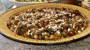 A pizza with mushrooms and feta cheese on top.