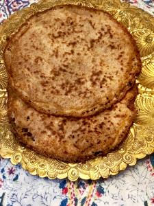 A close up of two cookies on top of a yellow plate.