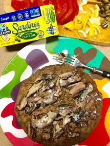 Sardines on savory pancake on colorful plate