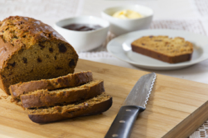 A knife and some bread on a cutting board
