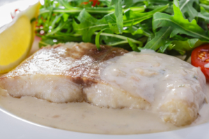 A plate of food with meat and vegetables.