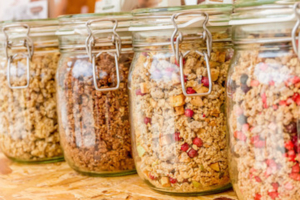 A close up of several jars filled with different kinds of food