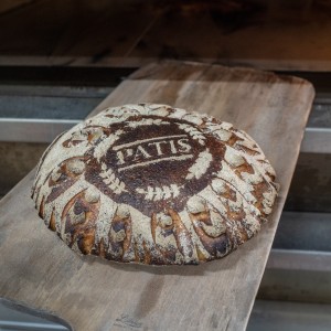 A round pastry sitting on top of a wooden board.