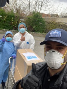A group of people wearing masks and standing around.