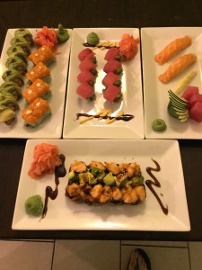 A table with several plates of different types of food.