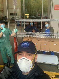 A man wearing a hat and mask in front of two other men.