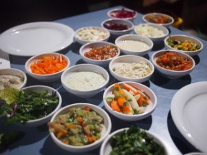 A table with many bowls of food on it