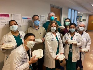 A group of doctors and nurses wearing masks.