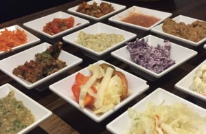 A table with many different types of food in bowls.