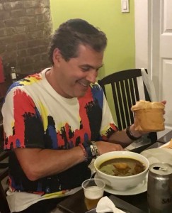 A man sitting at the table with food.