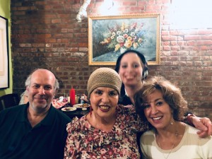 Smiling group of friends by brick wall