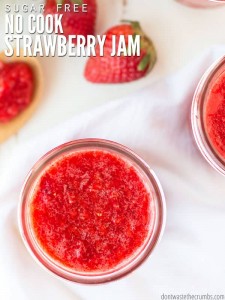 A bowl of strawberry jam on top of a table.