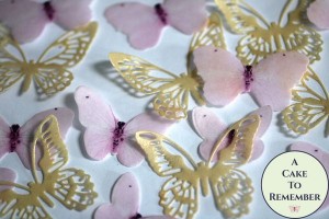 A close up of some pink and gold butterflies