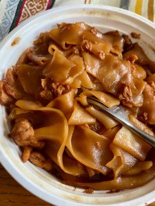 A close up of a bowl of food with meat