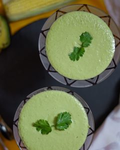 Two green desserts are sitting on a table.