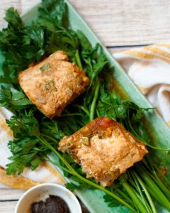A plate of food with meat and greens.