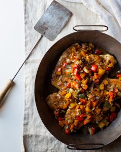 A pan of food with meat and vegetables.