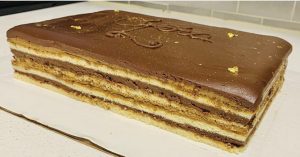 A large piece of cake with chocolate icing.