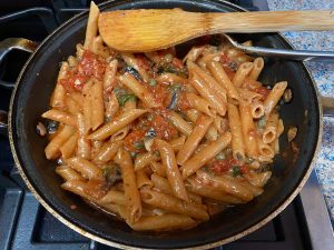 A pan of pasta with meat sauce and cheese.
