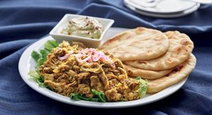 A plate of food with pita bread and salad.