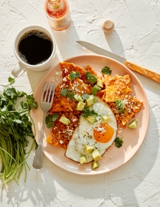 A plate of food with an egg on top.