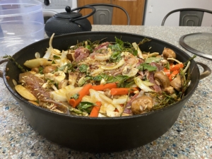 Cast-iron pan with roasted vegetables and herbs