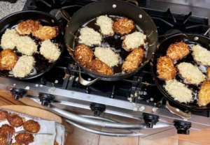 A bunch of food is cooking in the kitchen